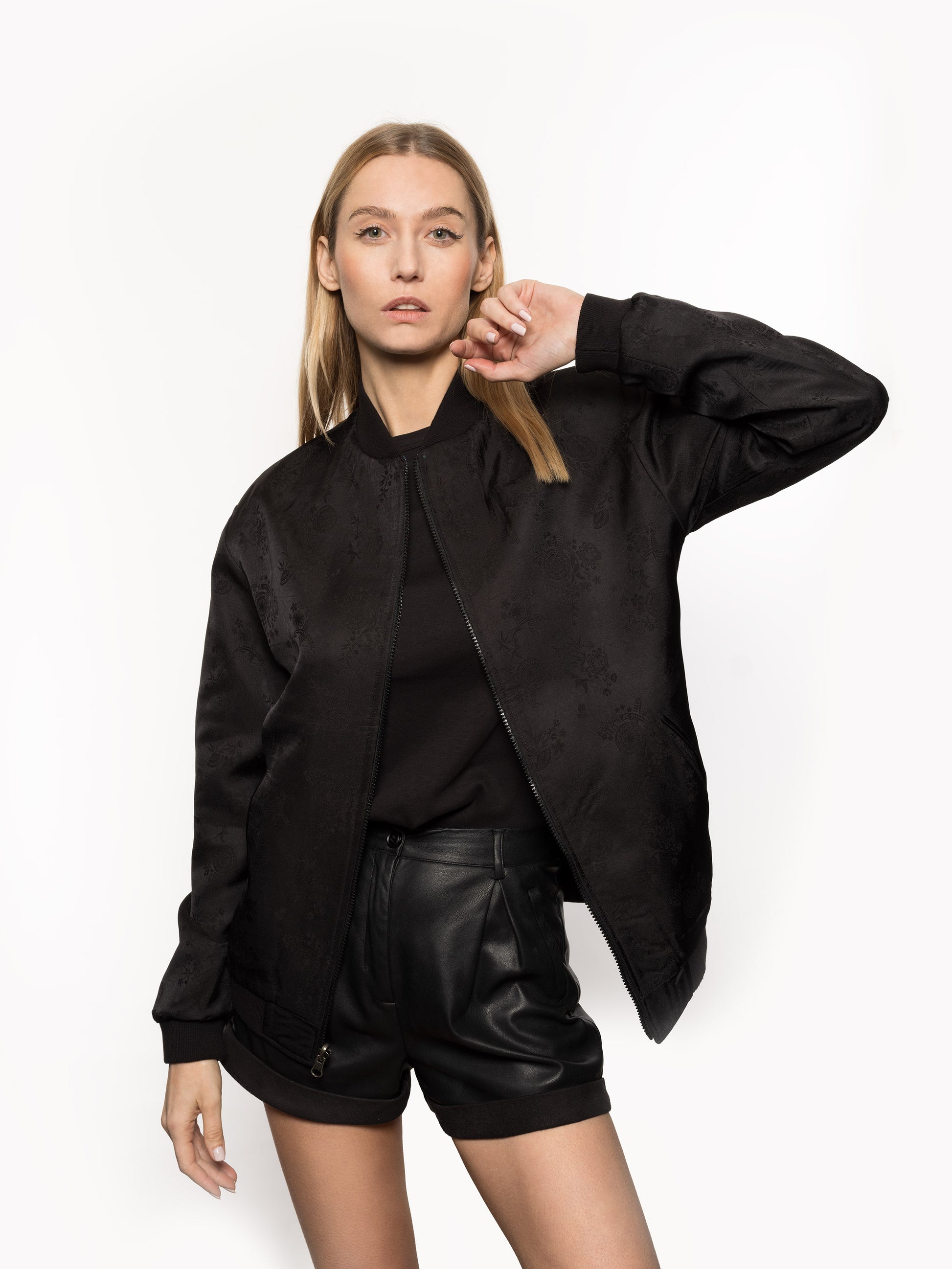 "Introducing Kaelu's exclusive 'DJINN' silk bomber jacket, numbered 1 to 20. Meticulously crafted in Vietnam using authentic Vietnamese silk, this reversible marvel features a refined blend of green and black, exuding subtle classiness. Unlike the bold Japanese sukajan, this piece offers understated luxury with a nod to urban sophistication."