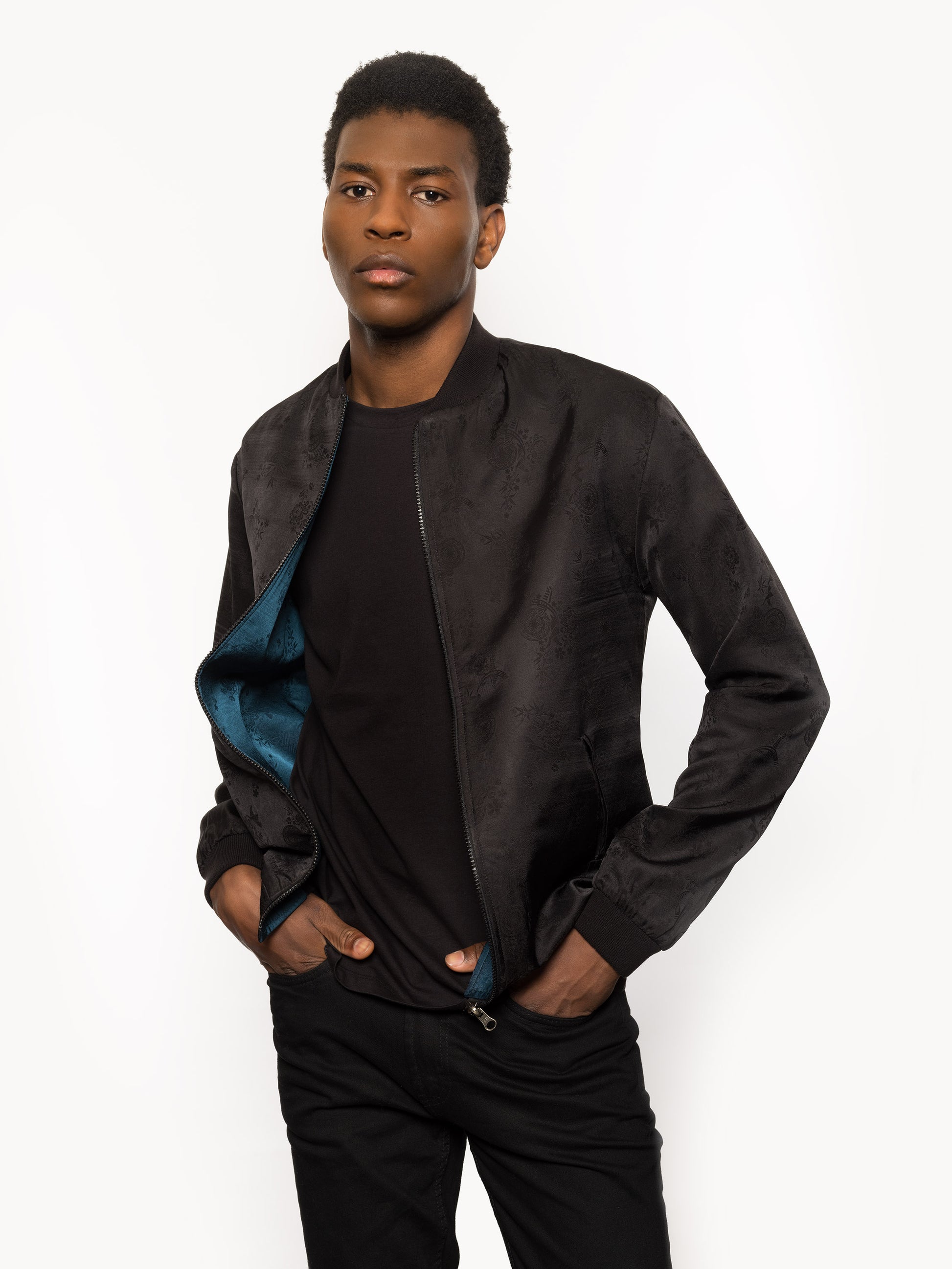 "Introducing Kaelu's exclusive 'DJINN' silk bomber jacket, numbered 1 to 20. Meticulously crafted in Vietnam using authentic Vietnamese silk, this reversible marvel features a refined blend of green and black, exuding subtle classiness. Unlike the bold Japanese sukajan, this piece offers understated luxury with a nod to urban sophistication."