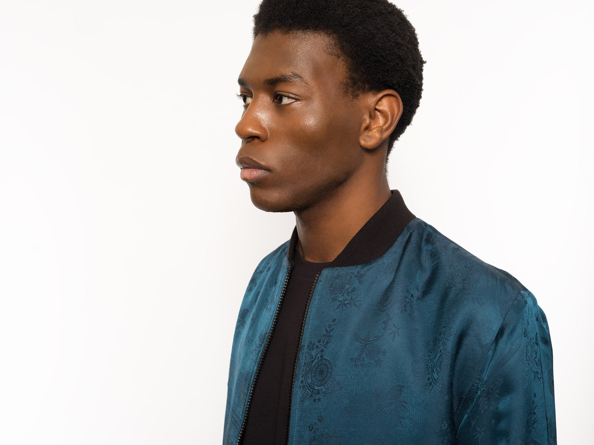 "Introducing Kaelu's exclusive 'DJINN' silk bomber jacket, numbered 1 to 20. Meticulously crafted in Vietnam using authentic Vietnamese silk, this reversible marvel features a refined blend of green and black, exuding subtle classiness. Unlike the bold Japanese sukajan, this piece offers understated luxury with a nod to urban sophistication."