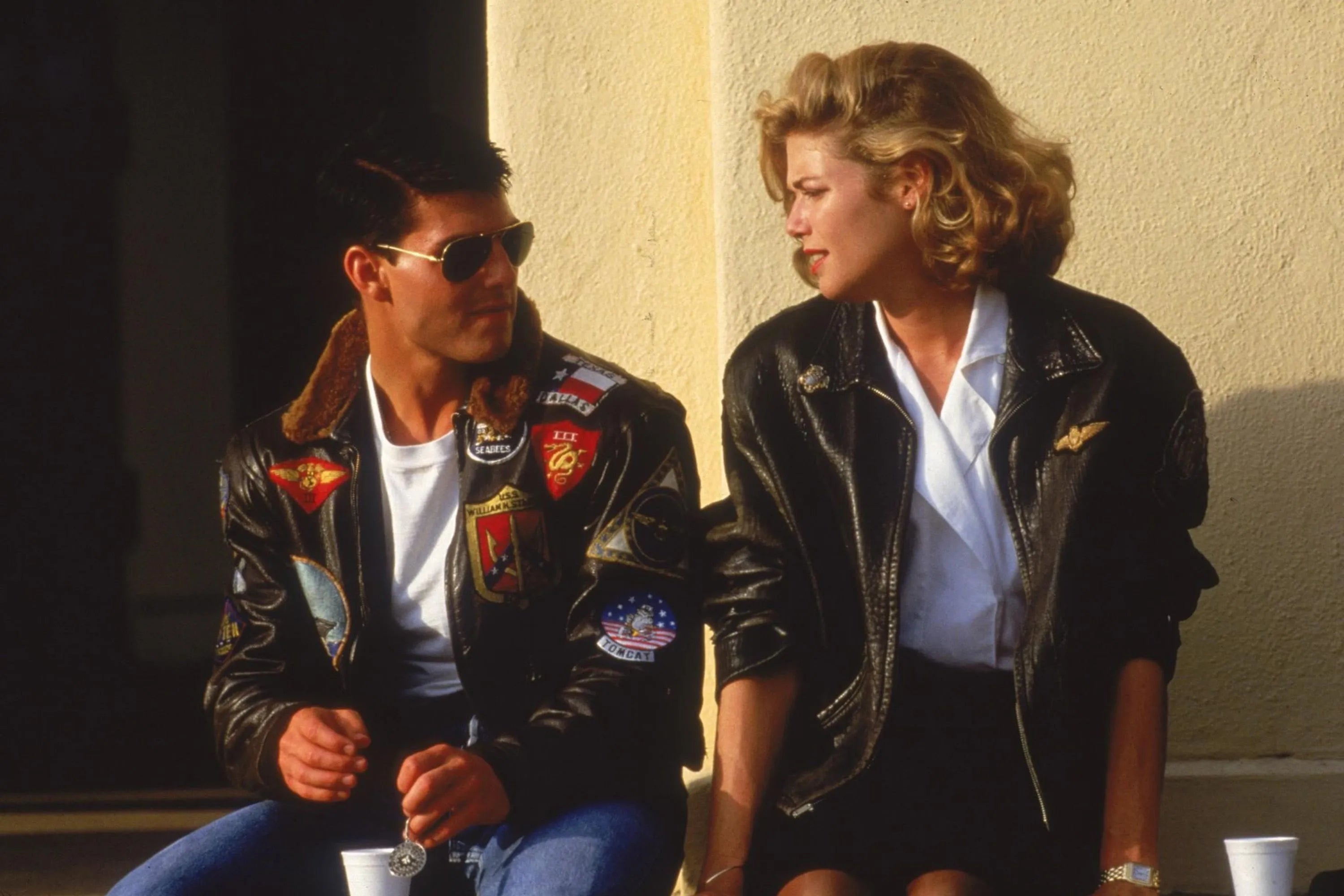 Tom Cruise and Kelly McGillis wearing a bomber jacket in Topgun