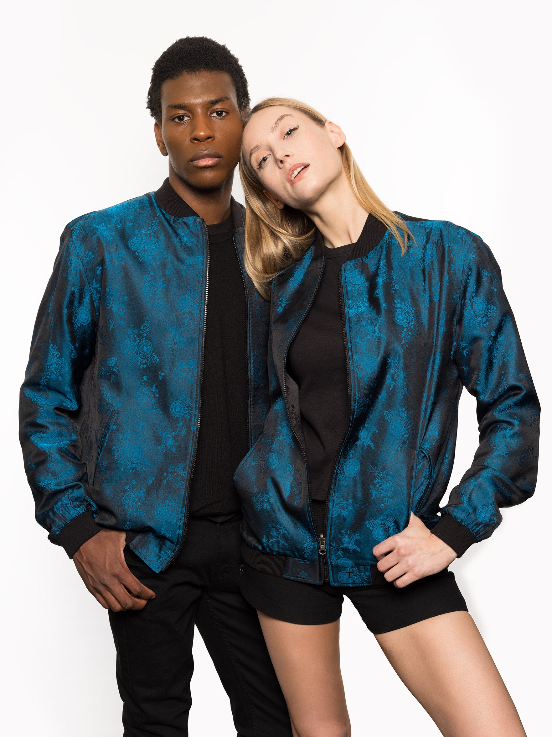 "Kaelu's limited edition 'DJINN' silk bomber jacket, numbered 1 to 20. Handcrafted in Vietnam with authentic Vietnamese silk, this reversible jacket offers versatility with one side in striking blue and the other in sleek black. Combining Asian luxury with urban style, it's fairtrade and fashion-forward, epitomizing streetwear sophistication."
